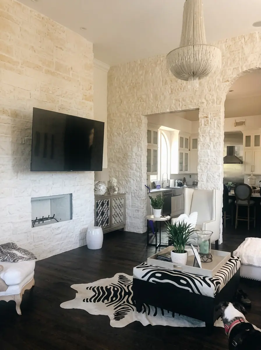 Open-concept living room with stone accent wall, linear fireplace and dark hardwood floors